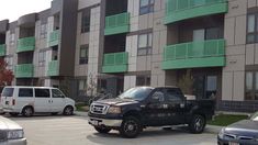 several cars parked in front of an apartment building