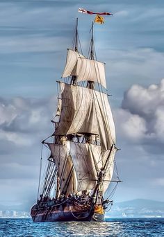 an old sailing ship in the middle of the ocean