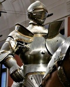 a large metal suit sitting on top of a horse