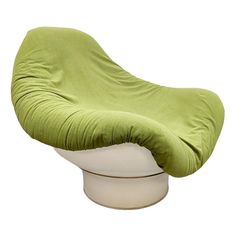 a green and white chair sitting on top of a table