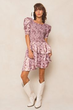 The Michelle Dress is the perfect mix of playful and chic. Made with a stunning purple floral knit fabric, this knee-length women's dress features a unique square neckline and 1/2 length fitted sleeves with a subtle puff at the cap. The asymmetrical tiered skirt adds a fun twist, while the hidden back zipper and smocked bodice provide a flattering fit. Maternity friendly too! Asymmetrical Tiered Skirt, Thanksgiving Dress, Girls Holiday Dresses, Purple Floral Dress, City Woman, Fitted Sleeves, White Dress Party, Holiday Party Dresses, Floral Knit