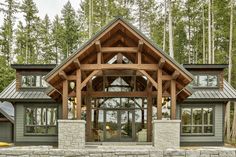 a large wooden and stone house in the woods