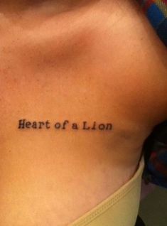 a woman's back with the words heart of a lion on it