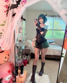 a woman taking a selfie in front of a mirror with her legs crossed and black boots on