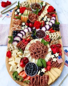 a platter filled with lots of different types of food on top of a table