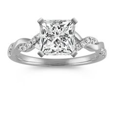 a princess cut diamond engagement ring with diamonds on the band and shoulders, set in 18k white gold