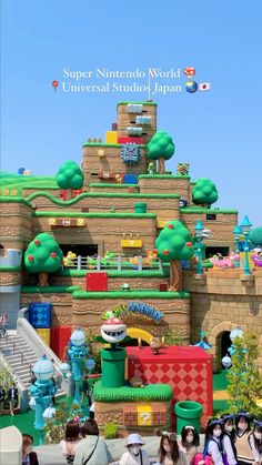 people are standing in front of a fake mario kart house at universal studios japan