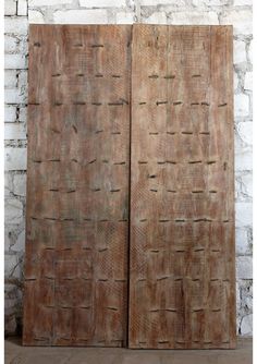 two wooden doors sitting next to each other