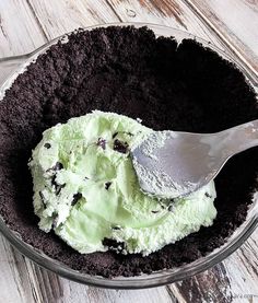 a scoop of ice cream in a bowl with chocolate chips and oreo cookies on top