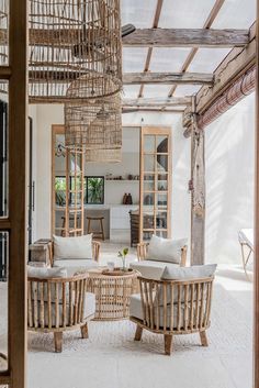 a living room filled with lots of furniture and decor on top of a white floor