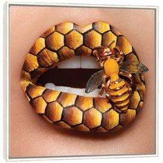 a woman's lip with a bee on it and honeycombs painted on the lip