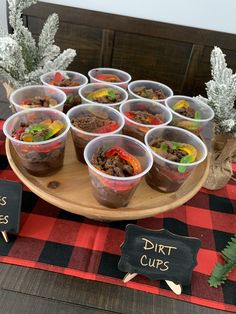 there are many desserts in plastic cups on the table for guests to take home