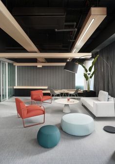 a living room filled with lots of white furniture and colorful pillows on top of it