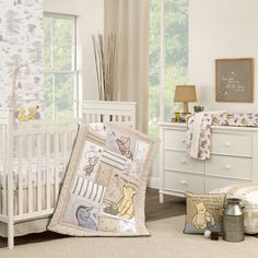 a baby's room with winnie the pooh crib bedding and furniture