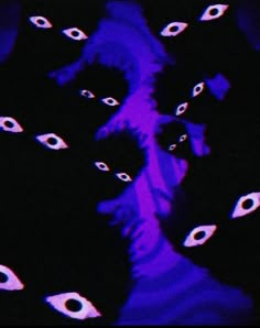 an image of some black cats in the dark with purple lighting on it's face