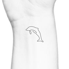 a black and white photo of a hand with a dolphin tattoo on it's arm