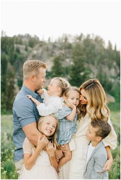 a family posing for a photo in the mountains