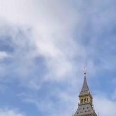 the big ben clock tower towering over the city of london on a partly cloudy day