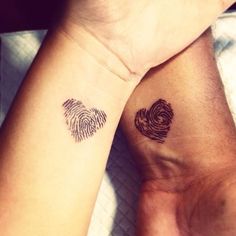 two people with matching tattoos on their arms