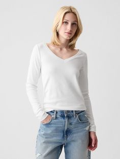 Soft knit stretch cotton and modal t-shirt.  V-neck.  Long sleeves.  Straight silhouette with a loose fit.  Hits at the hip.  Models wearing Gap Petite Size, White Long Sleeve, Soft Knits, Stretch Cotton, Black And Navy, Heather Grey, V Neck T Shirt, Gap, Loose Fitting