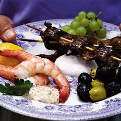 a blue and white plate topped with different types of food