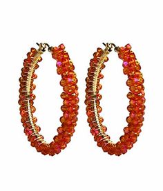 pair of hoop earrings with orange beads and gold accents on each earring, set against a white background