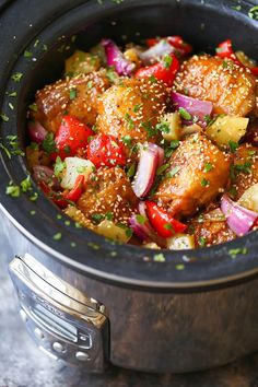 a bowl filled with meat and vegetables on top of a table