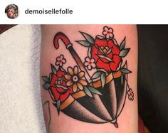 an umbrella and flowers tattoo on the arm