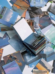 a pile of pictures sitting on top of a table