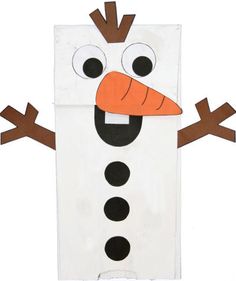 a paper bag that has a snowman face on it, with eyes and nose