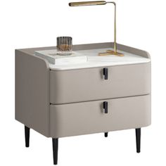 a white table with two drawers and a gold faucet on the top, in front of a white background