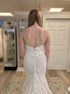 a woman in a wedding dress looking at her reflection