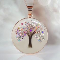 Beautiful handmade item! Here, on Etsy made as simulation only-just resin and white color.  If you need to send the hair to us, please send the hair right after the purchase to: KEEPSAKEMOM CREATIONS 1733 H ST, STE 450 PMB 2775 BLAINE WA 98230 "Tree of Life" disc pendant with baby hair and birth color flakes and shimmers, baby name, date. Yellow or Rose Gold plating over 925 sterling silver cup and chain. This pendant is made with white resin only, no milk. Our "Tree of Life" Pendant necklace is a simple, tasteful 20mm circle  has a 20 inch flat cable chain. We can put a lock of hair from one child or from two or three of your children or your loved one. Please specify in the drop-down menu if you want birth month color shimmer and/or name.  For jewelry made with your  breast milk, please White Round Necklace For Memorial, White Memorial Necklace, White Round Necklaces For Memorial, Handmade White Jewelry For Keepsake, White Necklaces With Pressed Flowers For Mom, White Hypoallergenic Spiritual Necklace, Hypoallergenic White Necklace For Personalized Gift, Spiritual White Hypoallergenic Necklace, Personalized White Necklace