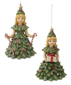 two christmas ornaments are hanging from the ceiling and one is holding a candy cane in its hand