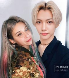 two women with long hair posing for the camera