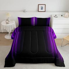 a bed with purple and black sheets in a room