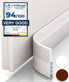 the corner of a white wall next to a brown and white sticker that says 9 / 4 / 100 very good