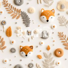 an assortment of felt animals and leaves on a white surface with the word fox spelled out