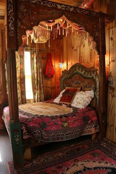 a bed in a room with wooden walls and carpeted flooring on both sides