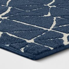 a blue and white area rug with an abstract design on the bottom half of it