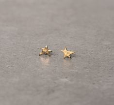 "Minimalist gold plated stud earrings, Tiny stud earrings, Everyday posts, Star Studs. A basic goes-with-anything gold plated stud earrings. These star-shaped earrings are hand made with matte finish design which adds lots of character and a \"handmade look\". Simple and modern, these studs look fab worn together in multiple piercings, or worn as a mismatched pair! Unique minimalist stud earrings that will look great with any outfit you'll wear and add BLING to your look. They are light and comf Stack Earrings, Tiny Gold Earrings, Gold Minimalist Jewelry, Unique Studs, Multiple Earrings, Stud Earrings Unique, Star Dust, Earrings Star, Star Stud Earrings