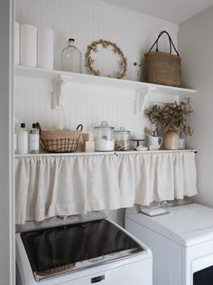 a white washer and dryer sitting next to each other in a laundry room