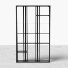 a black bookcase with four shelves on one side and two open ones on the other