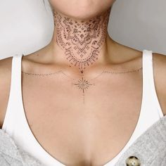 a woman with a neck tattoo that has intricate designs on her chest and back side