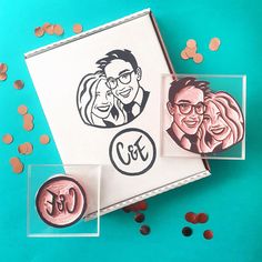 two rubber stamps and some confetti on a blue background