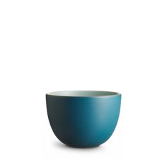 a blue bowl sitting on top of a white table