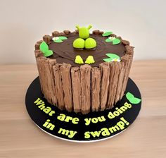 there is a cake that has been made to look like a tree stump with the words what are you doing in my swamp?