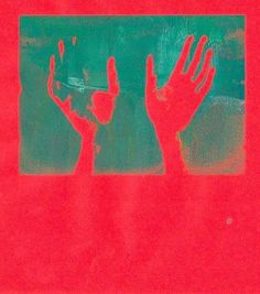 two hands reaching up in front of a red background