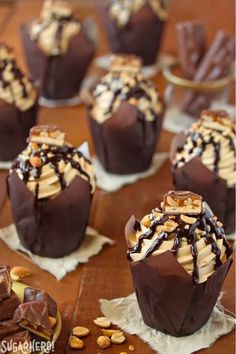 chocolate covered desserts with nuts and caramel drizzled on the top