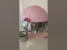 a pink lamp sitting on top of a white table